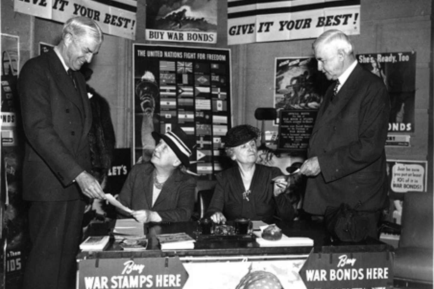 Susan Vaughn Clayton and Mary Gibbs Jones sell war bonds from a desk in the RFC building. Photo courtesy of Rice University’s Woodson Research Center.